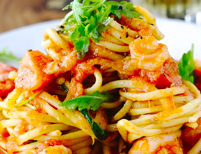 A close up of some pasta with sauce and vegetables