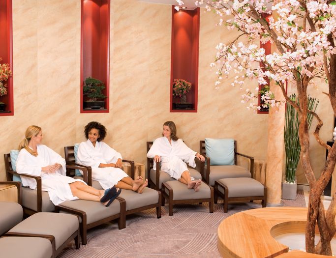 Three people sitting in a spa waiting for the massage.