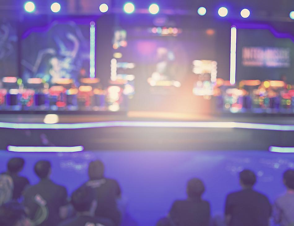 A group of people sitting in front of a stage.