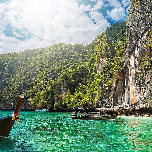 A boat in the water near some cliffs