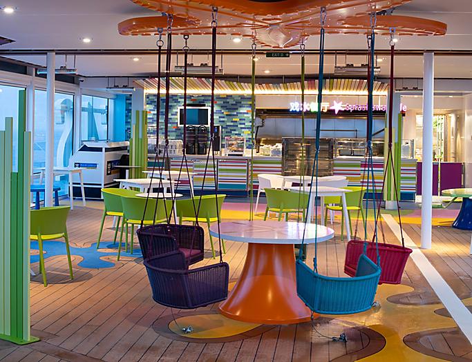 A restaurant with colorful tables and chairs in the center.