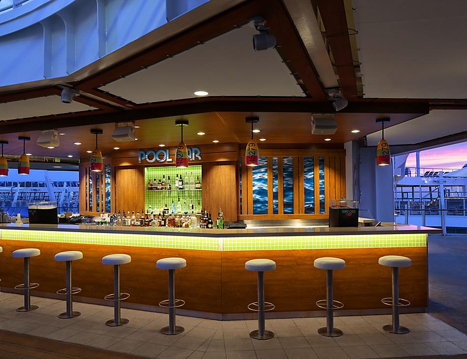 A bar with several stools in front of the bar.