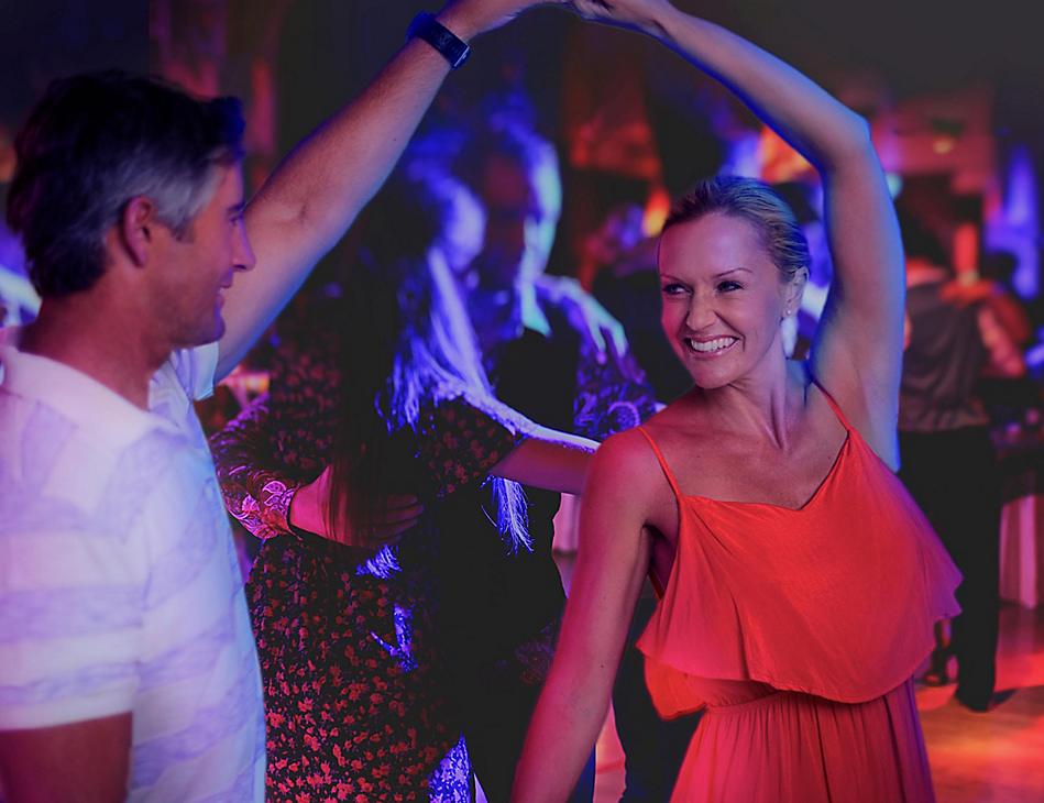 A man and woman dancing in front of a crowd.