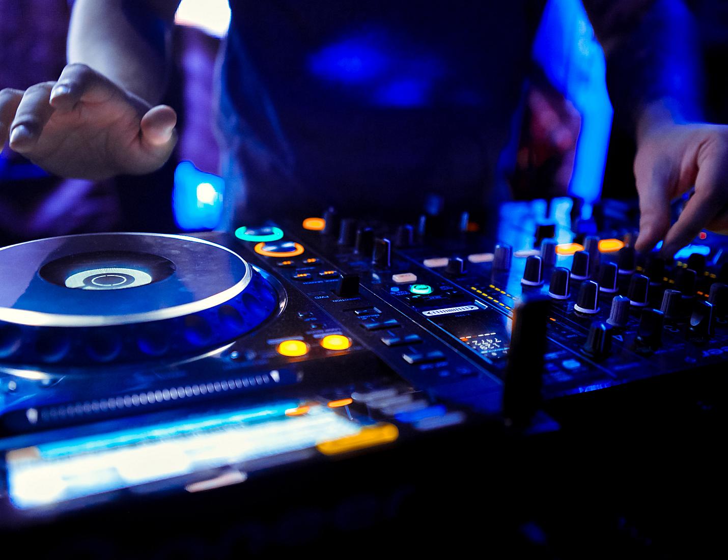 A person is playing some music on the dj decks