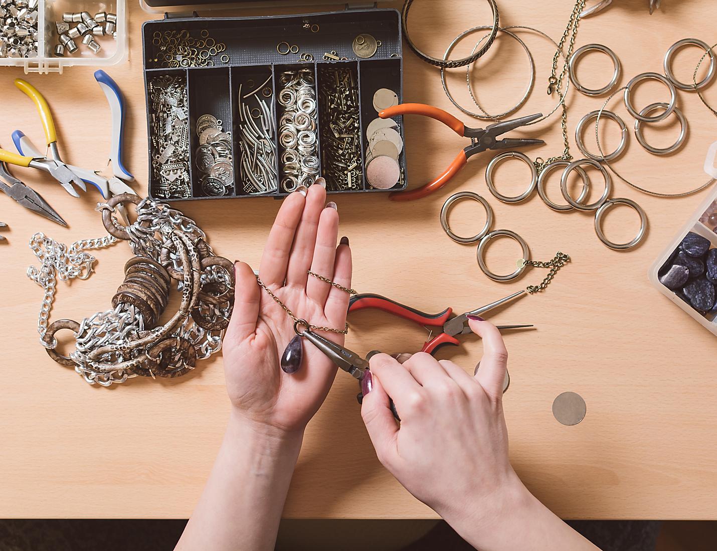 A person holding scissors and working on some kind of object