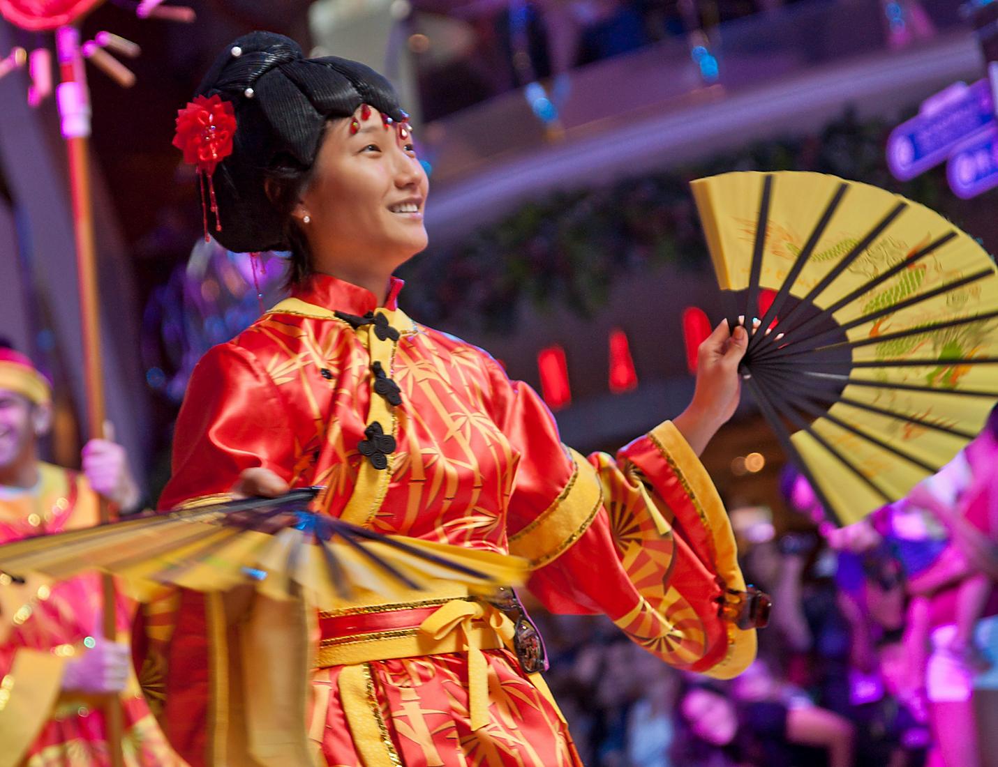 A woman in traditional chinese clothing holding an umbrella.