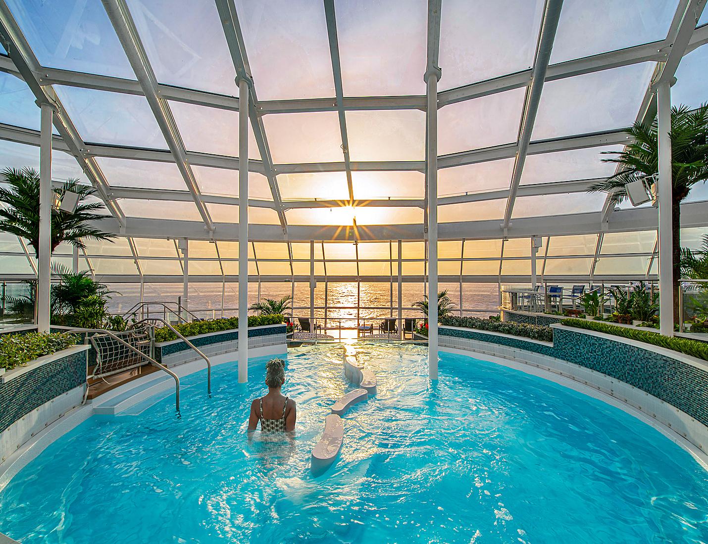 A person in the pool at sunset