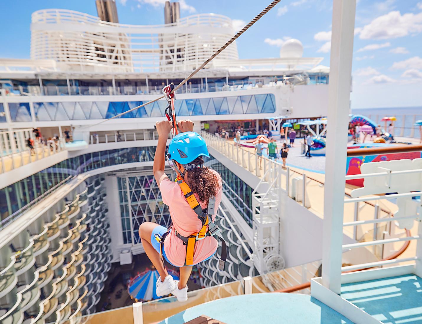 A woman is ziplining on the deck of a cruise ship.